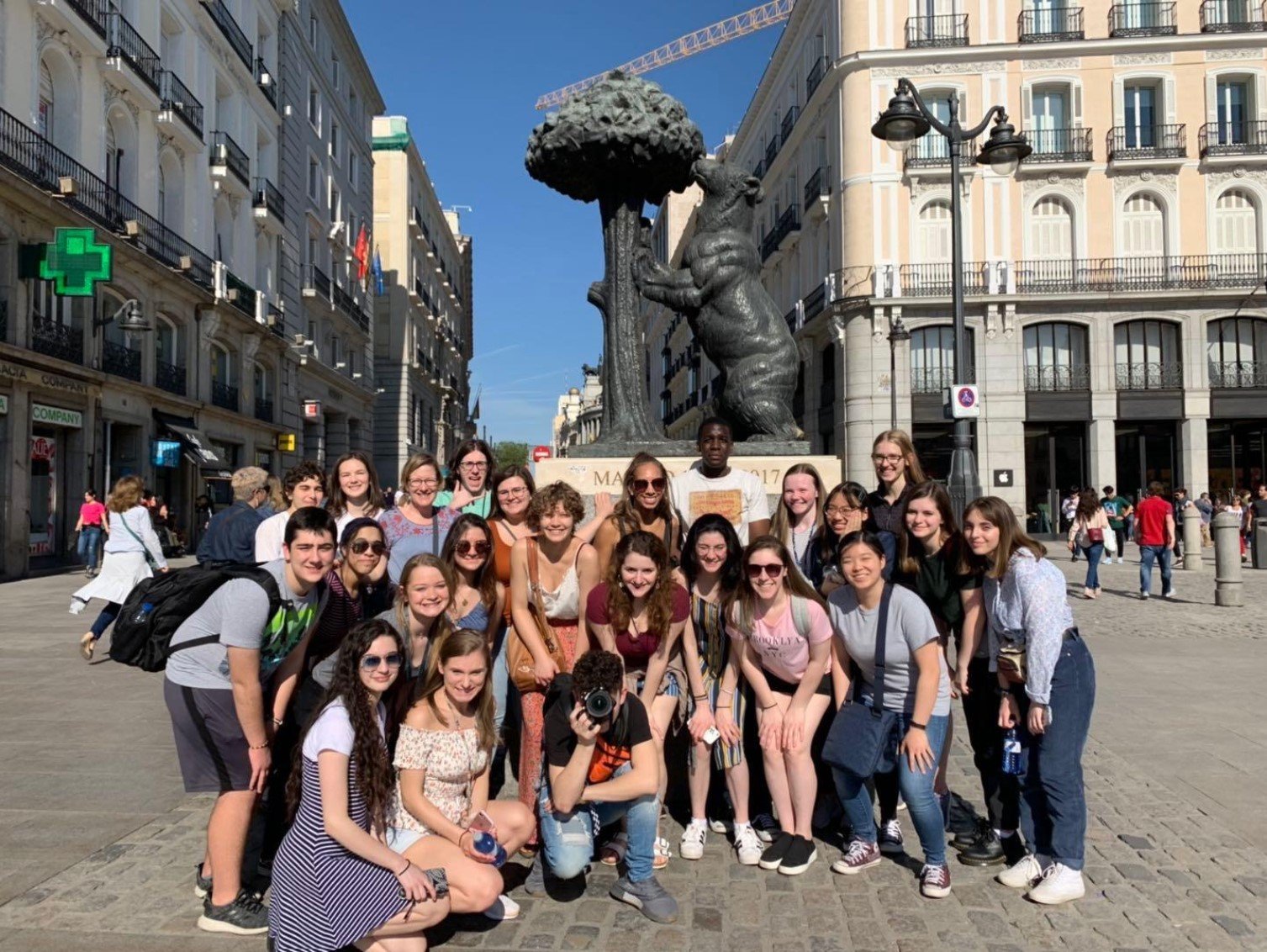 A Student Study Tour Group takes a picture in front of the El Oso y el Madroño statue in Madrid, Spain.